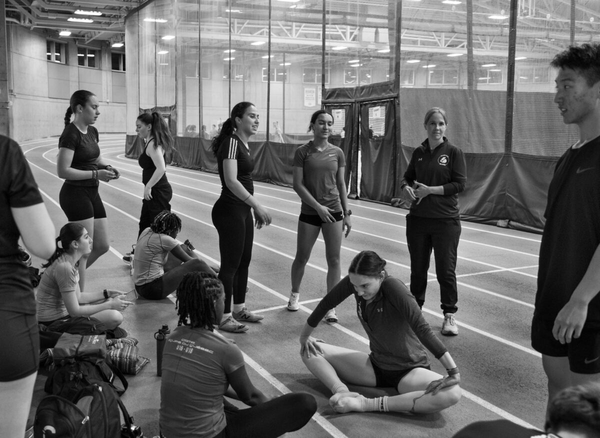 Les membres de l'équipe de cross-country du Collège Dawson s'étirent et discutent après un entraînement.